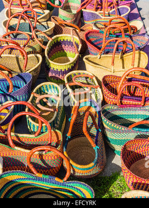 Stacks of colorful handmade woven baskets on display at a Mexican Stock