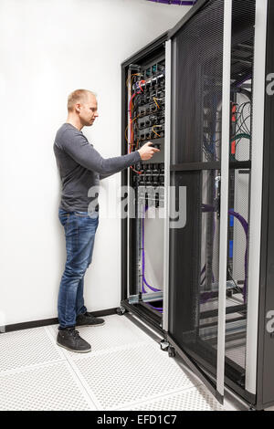IT consultant build network rack in datacenter Stock Photo