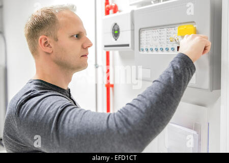 Technician test fire panel in data center Stock Photo