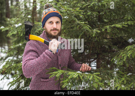 Lumberjack near the christmas tree in forest Stock Photo