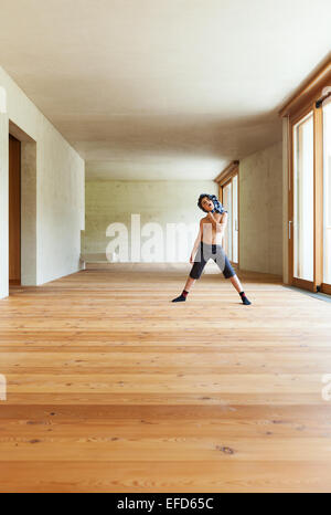 new apartment, room with concrete walls, boy inside Stock Photo