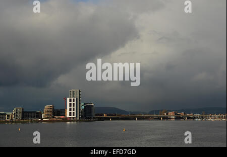 Cardiff Bay from barrage with dark storm clouds apartments and road bridge Stock Photo