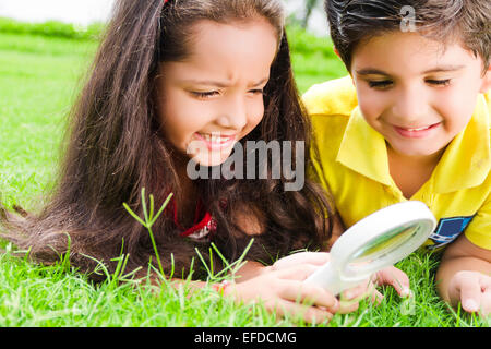 2 indian children friend park Magnifying Glass Searching Stock Photo