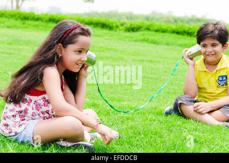 2 indian children friend park toy phone talking Stock Photo