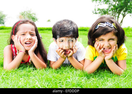 3 indian children friends park fun Stock Photo