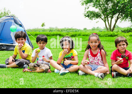 indian children group friends friends Picnic Park Eating Apple Stock Photo