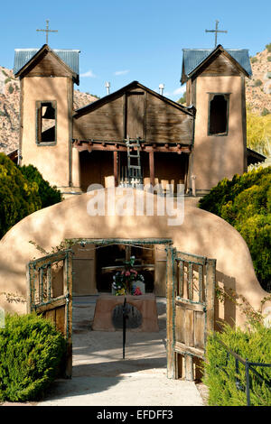 Adobe gate and Santuario de Chimayo, Chimayo, New Mexico USA Stock Photo