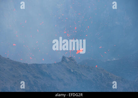 Melanesia, Vanuatu, Tanna Island. Mt. Yasur volcano. Crater overlook, view into steaming active volcano with molten lava. Stock Photo