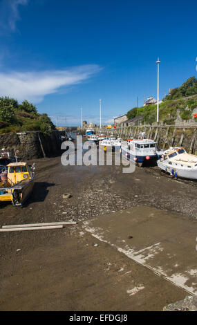 View of historic Amlwch Harbour with boats at low time. Amlwch, Anglesey, Wales, United Kingdom. Once famous for copper trade. Stock Photo