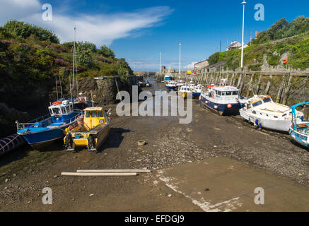 View of historic Amlwch Harbour with boats at low time. Amlwch, Anglesey, Wales, United Kingdom. Once famous for copper trade. Stock Photo