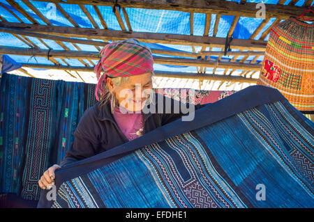 Hmong woman with indigo clothes on sale, Sapa hill tribe region, Northern Vietnam, Asia Stock Photo