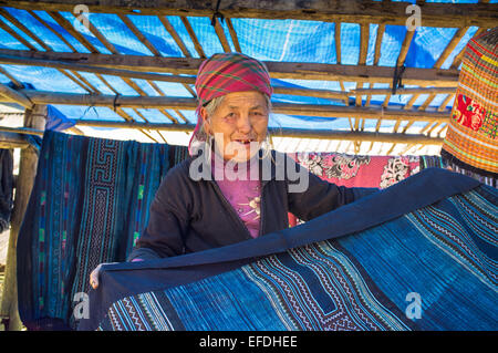 Hmong woman with indigo clothes on sale, Sapa hill tribe region, Northern Vietnam, Asia Stock Photo