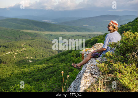 Hiking man in rays of sunset Stock Photo