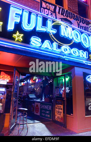 Nighttime neon competes for patrons at the Full Moon Saloon's live music venue on lower Broadway in downtown Nashville TN Stock Photo