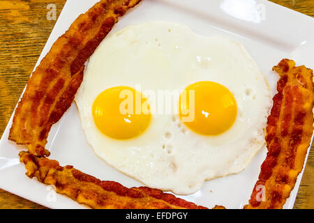 Bacon  and eggs on a white plate Stock Photo