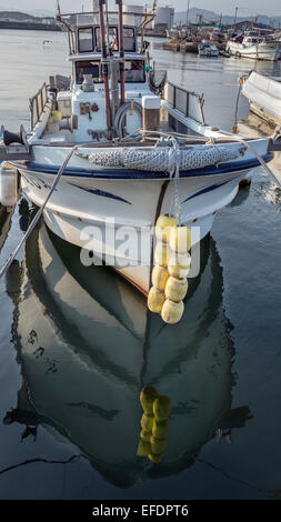 Fishing boat with reflection, Naruto Harbor, Shikoku Island, Japan Stock Photo