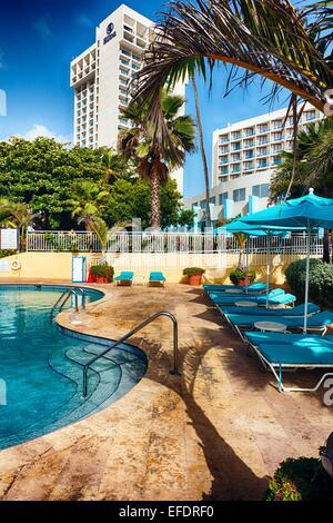 Low Angle View of Chaise Lounge Chairs at Poolside, Caribe Hilton, San Juan, Puerto Rico Stock Photo