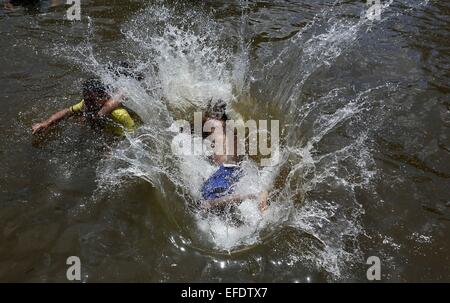 Piribebuy, Paraguay. 1st Feb, 2015. Turists jump into the water in the tourist complex of Pinamar, in Piribebuy city, Cordillera department, 80km away from Asuncion, capital of Paraguay, on Feb. 1, 2015. According to local press, Piribebuy city is crossed by seven creeks that are born on the nearby hills, and it has become an important part of the tourist circuit of Paraguay for its natural attractions. © Rene Gonzalez/Xinhua/Alamy Live News Stock Photo