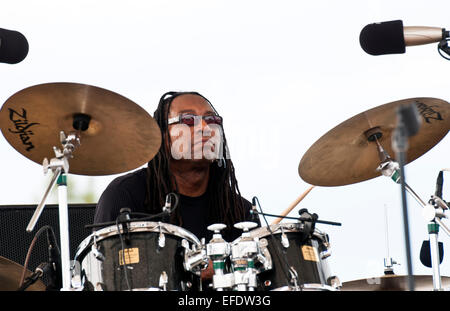 Black / African American drummer behind drum set on white background Stock Photo