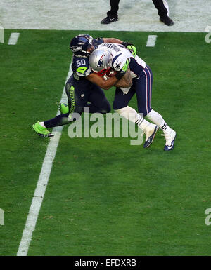 Glendale, Arizona, USA. 01st Feb, 2015. New England Patriots tight end Michael Hoomanawanui #47 is hit by Seattle Seahawks outside linebacker K.J. Wright #50 during the first half of Super Bowl XLIX between the Seattle Seahawks and the New England Patriots at University of Phoenix Stadium in Glendale, Az. © Action Plus Sports/Alamy Live News Stock Photo