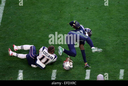 Glendale, Arizona, USA. 01st Feb, 2015. Seattle Seahawks cornerback Jeremy Lane #20 is hit be New England Patriots wide receiver Julian Edelman #11 after returning an interception during the first half of Super Bowl XLIX between the Seattle Seahawks and the New England Patriots at University of Phoenix Stadium in Glendale, Az. © Action Plus Sports/Alamy Live News Stock Photo
