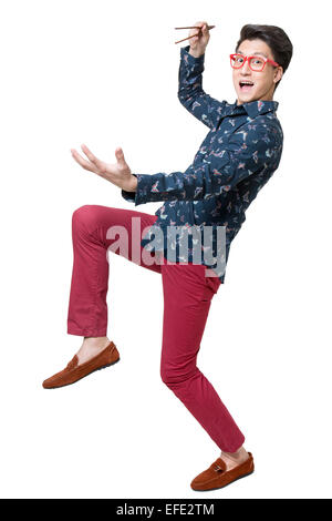 Happy young man using chopsticks Stock Photo