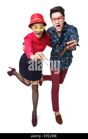 Happy young couple using chopsticks Stock Photo
