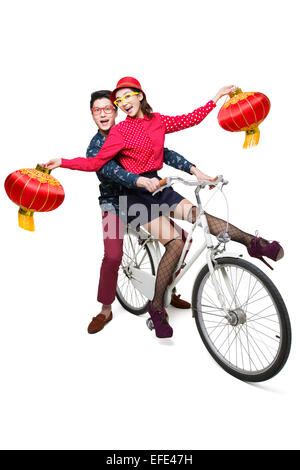 Young couple riding on a bike with Chinese lanterns Stock Photo