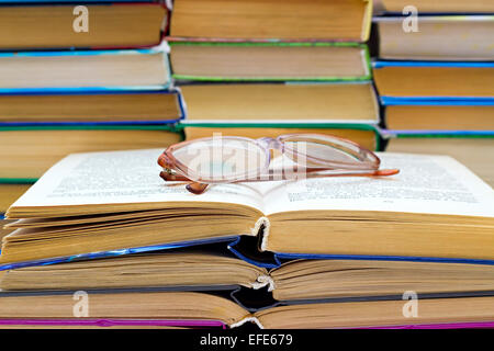 reading glasses lying on the open book Stock Photo