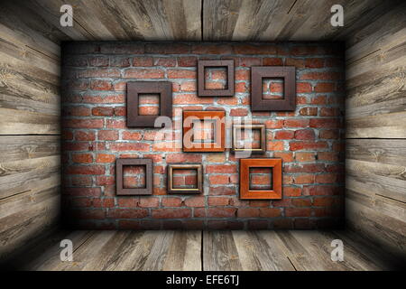 empty room with frames on abstract brick wall Stock Photo