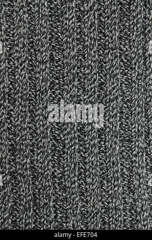 close up of an anthracite, black and gray flecked and striped knitted shawl, full frame, vertical Stock Photo