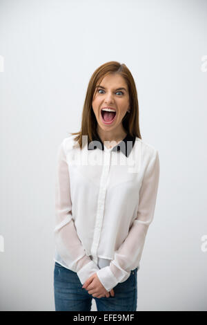 Angry businesswoman shouting over gray background Stock Photo