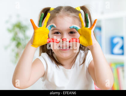 cute child have fun painting her hands Stock Photo