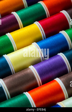 Selection of colored cotton threads used in sewing Stock Photo