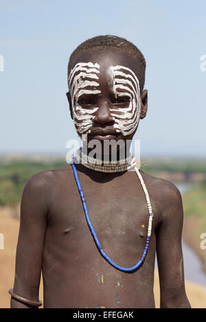 TURMI, ETHIOPIA - NOVEMBER 19, 2014: Karo Boy with traditional paintings on November 19, 2014 in Turmi, Ethiopia. Stock Photo