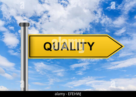quality words on yellow road sign on blue sky Stock Photo