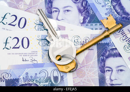 House keys on pound notes. Set of keys with banknotes. Stock Photo