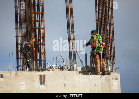 Two construction workers working on rebar and concrete foundation for building-Victoria, British Columbia, Canada. Stock Photo