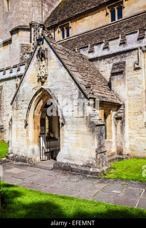 The porch of St. Andrew's church in the Cotswold village of Castle Combe in Wiltshire. Stock Photo