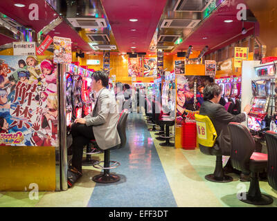 Man playing pachinko in a Tokyo game house Stock Photo