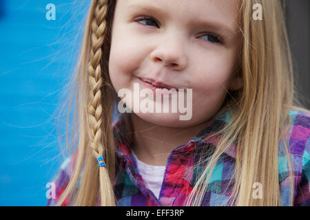 Young blonge girl with braid smirking. Stock Photo