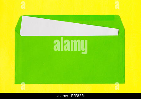 open green envelope with  blank paper on yellow background Stock Photo