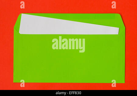 open green envelope with  blank paper on red  background Stock Photo