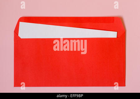 open red envelope with  blank paper on pink  background Stock Photo