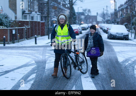 South London, UK. 03rd Feb, 2015. Picture shows Lisa and Sean Kerry making their way to school in Wimbledon, South Wimbledon, where there has been snow showers across parts of London. Credit:  Jeff Gilbert/Alamy Live News Stock Photo