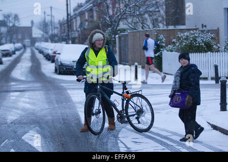 South London, UK. 03rd Feb, 2015.  Picture shows Lisa and Sean Kerry making their way to school in Wimbledon, South Wimbledon, where there has been snow showers across parts of London. Credit:  Jeff Gilbert/Alamy Live News Stock Photo