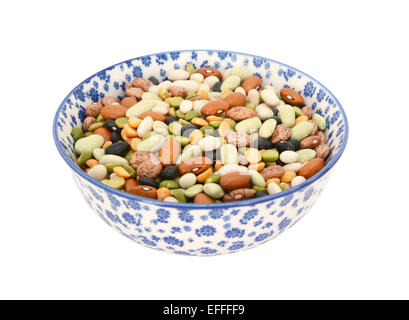 Mixed dried beans - in a blue and white porcelain bowl with a floral design, isolated on a white background Stock Photo