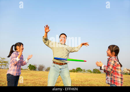 happy family playing with hula hoops outdoors Stock Photo