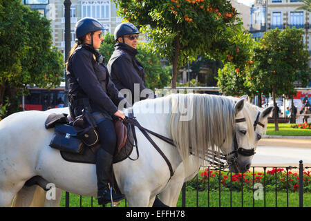 Two national mounted police officers on white horses in Valencia Spain Stock Photo