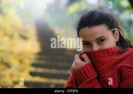 beautiful woman freezing in autumn park Stock Photo